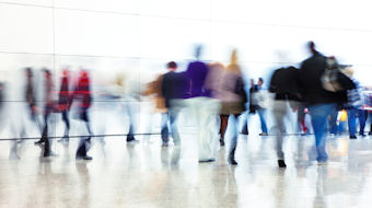 The bank we're becoming People in motion, blurred activity on polished floor concourse