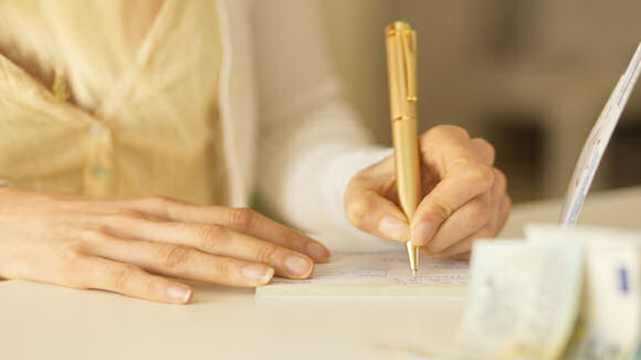 woman writing a cheque