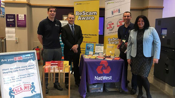 NatWest CEO of Personal and Business Banking, Les Matheson and others at the NatWest Norwich branch launching the little book of big scams