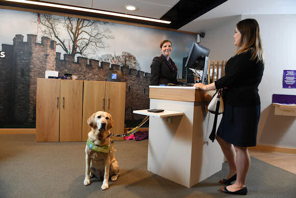 Andrea Salt with Edie, her guidedog, at NatWest’s Cardiff Queen Street branch.