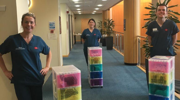 hospital staff with rainbow boxes