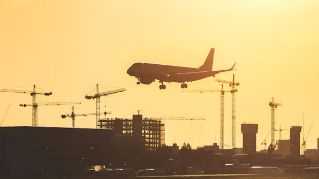 Airplane landing at sunset at London City airport